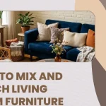 A blog header banner graphic displaying an eclectic living space with text overlay reading "HOW TO MIX AND MATCH LIVING ROOM FURNITURE", showcasing a navy blue sofa, textured throw pillows, a wicker armchair, and potted house plants to help readers learn to mix and match living room furniture